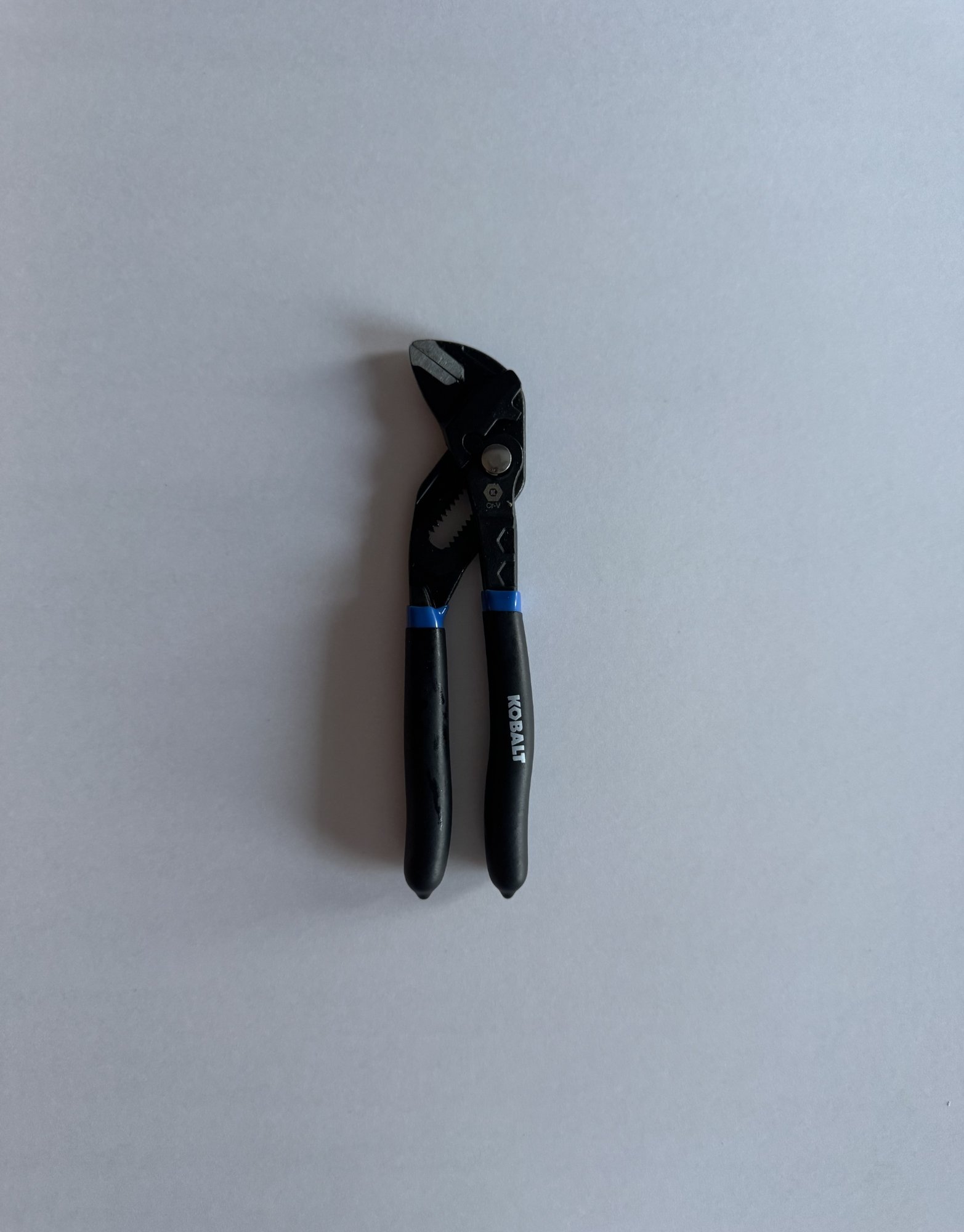 Step 1: A pair of pliers laid flat on a sheet of white paper, ready to be photographed from directly above for tracing.